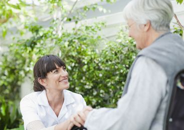 Home helper accompanies an elderly person.