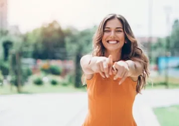 Happy young woman in the street.