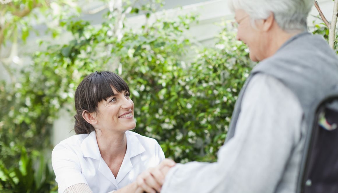 Home help accompanies a senior citizen.